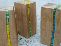 three wooden blocks with different colored glass beads on the sides and one is made out of wood