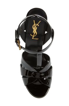 An icon since it first debuted on the runway, Saint Laurent's stylishly strappy Tribute sandal is lifted by a soaring tapered heel and beveled platform sole. 5" (127mm) heel; 1 1/4" platform (size 38.5) Adjustable ankle strap with buckle closure Leather upper, lining and sole Made in Italy Women's Designer Shoes Ysl Strappy Heels, Yves Saint Laurent Sandals, Designer Black T-strap Sandals Luxury, Saint Laurent Platform Heels, Luxury Designer Black T-strap Sandals, Leather Platform Sandals, Footwear Design Women, T Strap, Strappy Sandals