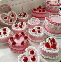 many heart shaped cakes with cherries on them