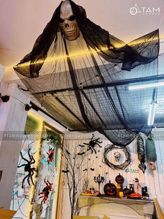 a room with halloween decorations on the ceiling