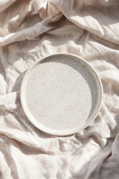 a white plate sitting on top of a bed