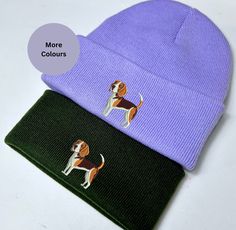 two beanies with beagle dogs on them, one is purple and the other is green