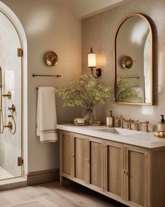 a bathroom with two sinks and mirrors in it