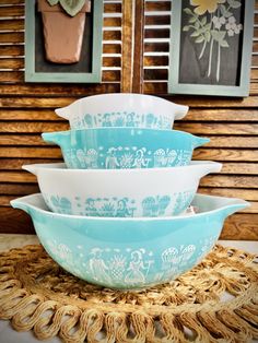 three blue and white bowls stacked on top of each other