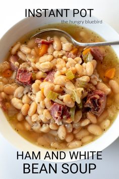 a bowl of ham and white bean soup with a spoon in it, on top of a table