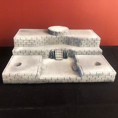 a model of a castle made out of white bricks