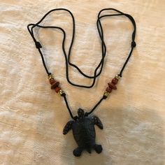 Pretty Adjustable Turtle Necklace. The Turtle Is Black And Made Of Wood. Measures 17 Inches. Nwot Black Casual Necklace With Adjustable Cord, Casual Black Necklace With Adjustable Cord, Handmade Black Necklace For The Beach, Handmade Black Necklace For Beach, Casual Black Pendant Jewelry, Casual Black Necklace For Gift, Black Beach Jewelry With Adjustable Cord, Casual Black Jewelry For The Beach, Casual Black Beach Jewelry