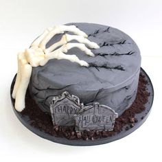 a halloween cake decorated with bones and tombstones