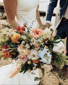 the bride and groom are holding their bouquets