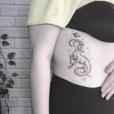 a woman with a goat tattoo on her stomach