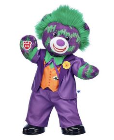 a purple and green clown stuffed animal on a white background with one hand in the air