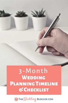 a person holding a pen and writing on a notebook with three potted plants in the background