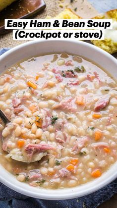 a white bowl filled with ham and bean soup on top of a blue napkin next to bread