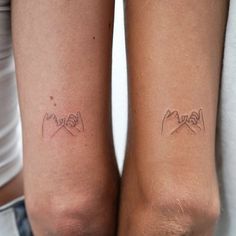 two people with matching tattoos on their arms