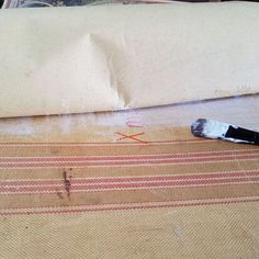 a brush is laying on the floor next to a pillow that has been placed on it