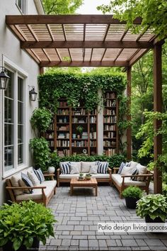 an outdoor living area with bookshelves, couches and potted plants on the patio