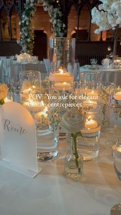 a table topped with lots of candles and vases filled with flowers next to each other