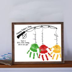 a wooden frame with a drawing of two children's handprints on it