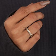 a woman's hand with a diamond ring on it