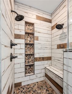 a walk in shower sitting next to a white tiled wall and wooden paneled walls