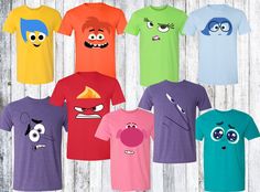 an assortment of t - shirts with cartoon characters on them, all in different colors