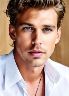 a close up of a person wearing a white shirt and necklace with blue eyes in front of a wooden wall