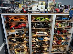 a room filled with lots of toy cars and shelves full of different types of toys