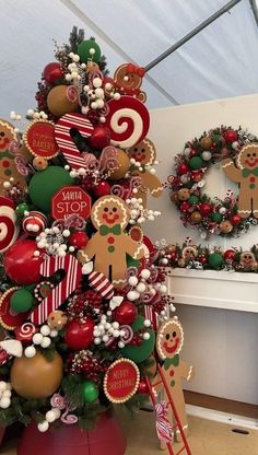 a christmas tree decorated with gingerbreads, candy canes and other holiday decorations