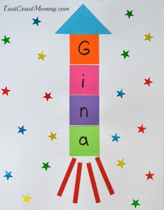 a rocket ship made out of colored paper with the letter g on it's side