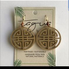 the earrings are made out of wood and have an intricate design