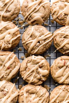 freshly baked cookies with icing drizzled over them on a cooling rack