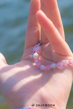 Flowing with effortless grace in a mesmerizing blend of blue and marine hues, this bracelet is a celebration of the ocean's hidden treasures, crafted with skillful artistry and woven with secrets waiting to be discovered. Material: Flower Glass Beads, Freshwater Pearls Craft: Handmade Size: 18-24cm Color: Pink Care: Keep away from chemicals; Avoid scratches; Clean with a soft fabric *This item is non-refundable. Handmade Elegant Beach Bracelets, Handmade Pink Strand Jewelry, Elegant Handmade Beaded Bracelets For Beach, Adjustable Single Strand Bracelet As Gift, Adjustable Single Strand Beaded Bracelets, Adjustable Single Strand Beaded Bracelet, Ocean-inspired Bangle Jewelry For Gifts, Adjustable Beaded Ocean-inspired Jewelry, Colorful Beaded Strand Bracelets As Gift