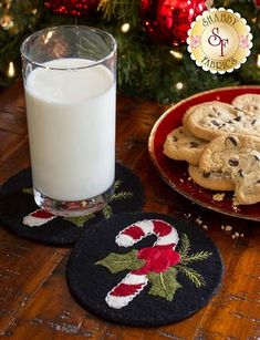 cookies and milk sitting on a table next to a christmas tree