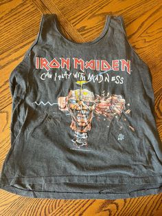 Iron Maiden 1988 sleeveless shirt. This shirt is VINATGE. This shirt was worn by a human for years, over 30 years ago, and therefore wear-and-tear is part of it. There may be imperfections, fade, etc. that I didn't account for. Vintage Tank T-shirt For Summer, Vintage Summer Tops For Concert, Vintage Tops For Summer Concerts, Casual Cotton Vest For Concert, Vintage Sleeveless Cotton T-shirt, Cotton Sleeveless Grunge Top, Sleeveless Cotton Grunge Tops, Sleeveless Grunge Cotton Top, Vintage Crew Neck Tank Top For Summer