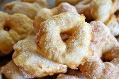 a pile of powdered sugar donuts sitting on top of a table