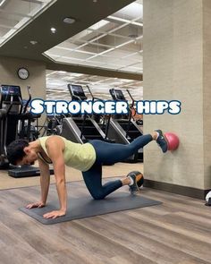 a woman doing push ups on a mat in a gym with the words, stronger hips