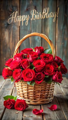 a basket filled with red roses sitting on top of a wooden table next to a sign that says happy birthday