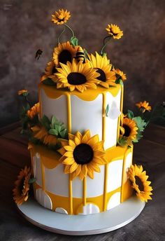 a yellow and white cake with sunflowers on top