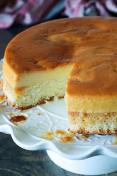 a cake that is sitting on a plate with one slice taken out of the cake