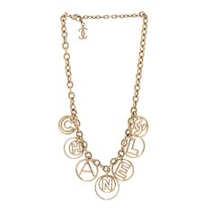 This is an authentic CHANEL Metal Hoop Cuba Logo Necklace in Gold. This stylish necklace is beautifully crafted in a light gold tone of chain links with large hoops with each hoop having a letter in the center that spells Chanel. This iconic necklace will compliment most any classic attire with a one of a kind look, from Chanel. Logo Necklace, Chanel Necklace, Gold Chanel, Stylish Necklace, Chain Links, Chanel Jewelry, A Letter, Necklace Gold, Cuba