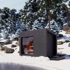 a small cabin sits in the snow near some trees