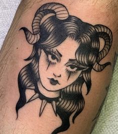 a woman with horns on her head is depicted in this tattoo design, which depicts the face of a demon