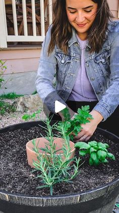 a woman is tending to plants in a pot