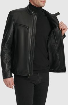 Bring a touch of moto edge to your cool-weather look with this leather jacket authenticated with a stand collar and tonal zip hardware. 25 1/2" length Front zip closure Stand collar Zip cuffs Chest zip pockets; front zip pockets Lined Leather Professional leather clean Imported Solid Biker Outerwear With Zipper Closure, Biker Style Solid Outerwear With Zipper Closure, Modern Black Leather Jacket With Zip Fly, Modern Black Leather Jacket, Classic Business Biker Jacket With Zipper Closure, Solid Biker Jacket With Zipper Closure For Workwear, Classic Leather Jacket With Zipper For Spring, Black Business Leather Jacket With Zip Cuffs, Black Leather Jacket With Zip Cuffs For Business