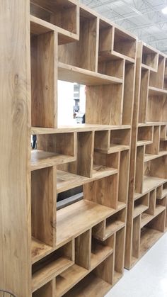 the shelves are made out of wood and have bookshelves built into each other