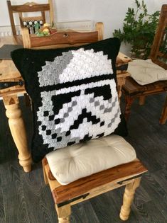 a cushion made to look like a stormtrooper pillow is sitting on a chair