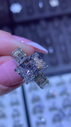 a woman's hand holding a fancy ring