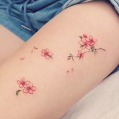 a woman's thigh with pink flowers on it