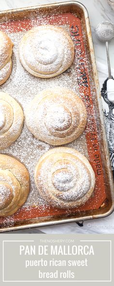 a pan filled with pastries covered in powdered sugar