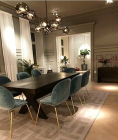 a dining room table with blue chairs in it